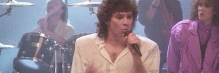 Bastidores e gravação da música Sara do Starship Mickey Thomas, vocalista do Starship, cantando ao vivo no palco durante a turnê de 1985.