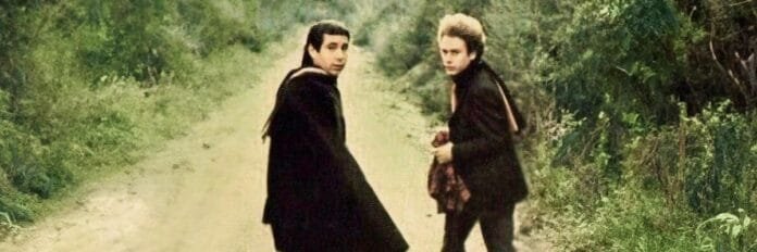 A música de apoio que causou a separação da dupla. Paul Simon e Art Garfunkel caminhando juntos com roupas de frio na época do lançamento do álbum no início dos anos 70.